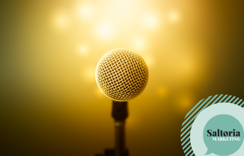 Microphone against goldish background to represent efficient tone of voice