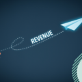 Picture of a paper plane flying towards the top right corner of the picture. It represents the concept of increasing revenue and using marketing for making money.